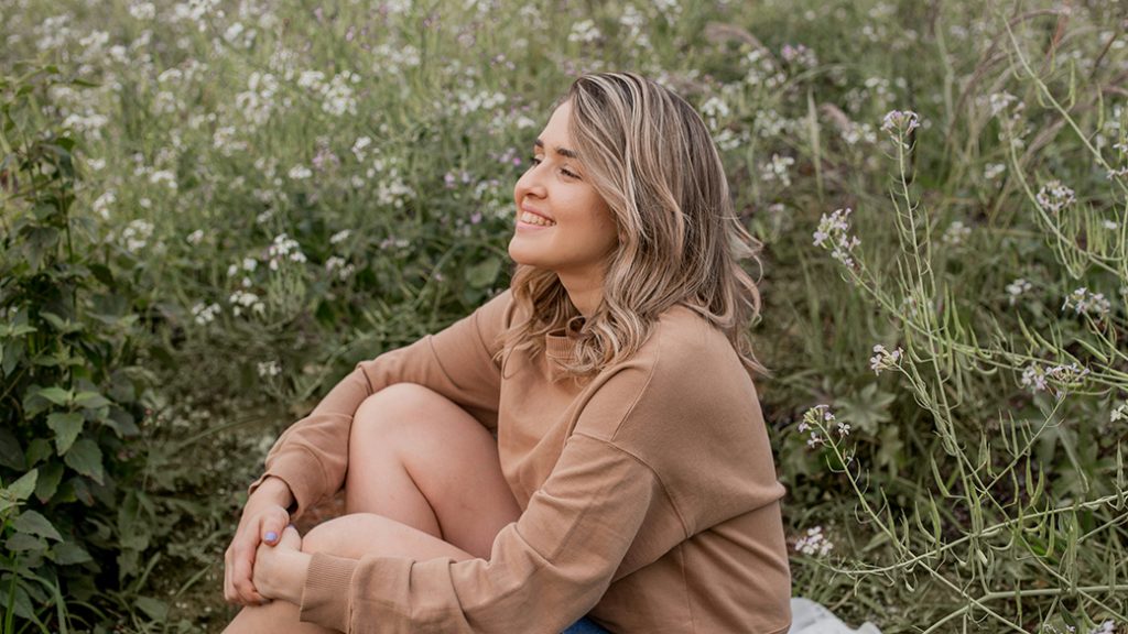 Smiling woman outdoors in warm sunlight